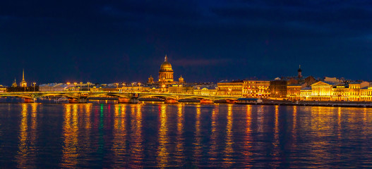 Fototapeta na wymiar Panorama of St. Petersburg. View of the Neva River embankment. View of St. Isaac's Cathedral. Neva River. Panorama of Russia. View of the center of St. Petersburg. Night Peter.