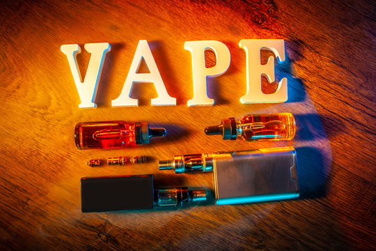 Popular vaping device mod. vape. vape smoke. The electronic cigarette is on the table. Liquids for VAPE