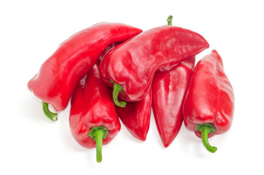 Pile of sweet red Kapia peppers on a white background