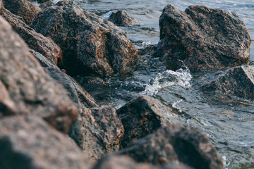 Stone shore and waves of the Gulf of Finland. North nature. Close-up view.