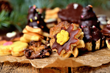 Christmas sweets with different types of candy on baking paper and Christmas decorations