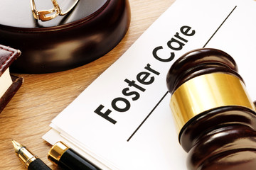 Foster care. Documents and gavel on a desk.
