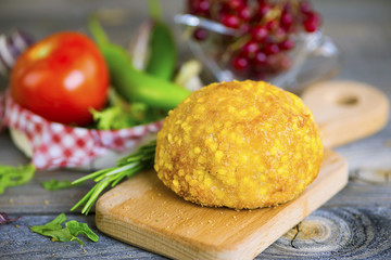 cutlet from turkey meat in batter on an old wooden background