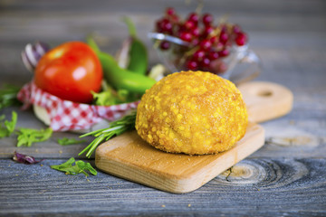 cutlet from turkey meat in batter on an old wooden background