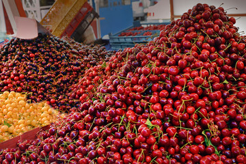 Different kinds of sweet cherries on the market. Sale of juicy fruits in the city of Varna,...