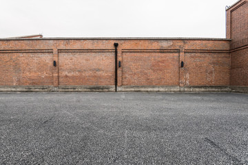 Brick wall and asphalt parking space
