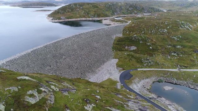 Aerial footage of a large stone dam for a Hydroelectric power station POI