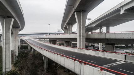 Aerial view of highway and overpass in city on a cloudy day
