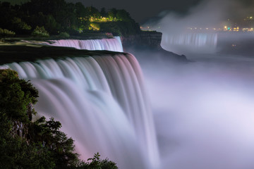 Niagara Falls lit at night by colorful lights, Niagara Falls, NY, USA
