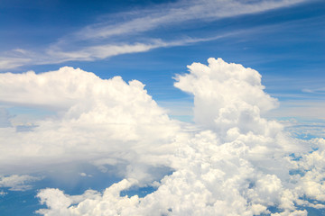 Naklejka na ściany i meble Beautiful view of blue sky above the white clouds from airplane window