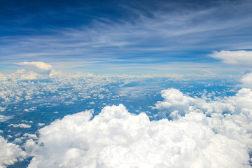 Beautiful view of blue sky above the white clouds from airplane window