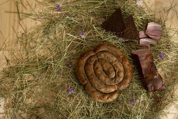 Rural food, cooked on organic farms, according to traditional recipes. Vegetables from the garden, cheese, meat and sausages spread out on a wooden table.