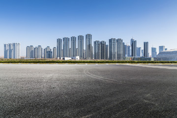 Panoramic skyline and modern business office buildings with empty road,empty concrete square floor