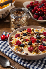 Breakfast, muesli with milk and fresh fruit.
