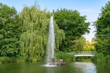 Lake with bridge, water fountain and herrin bird