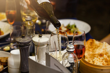 The process of pouring champagne into a glass