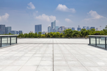 Fototapeta premium Panoramic skyline and modern business office buildings with empty road,empty concrete square floor