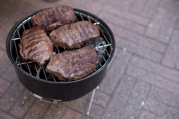Steaks of beef on the grill. Free space for text. Copy space.