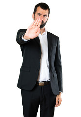 Handsome businessman making stop sign