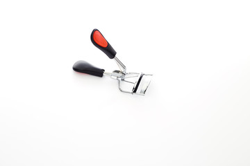 Eyelash curler on white background