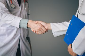 Fototapeta premium Two doctor shaking hands with working together.