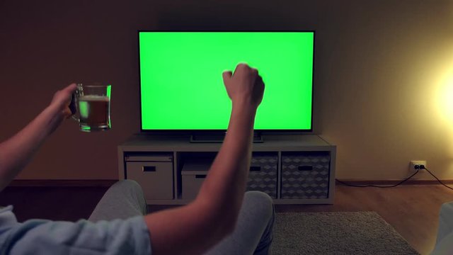 Watching tv with green screen at home interior