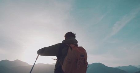 Young hiker reaching the top of mountain and raising his hands. Adventurer achieving a goal. Adventure, zen concept 4k