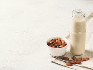 Obraz na płótnie Canvas Bottle with almonds milk and some almonds