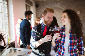Group of successful architects celebrating in office
