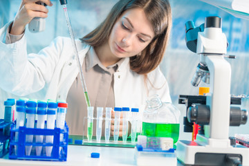 Chemical laboratory scientist woman working with pipette