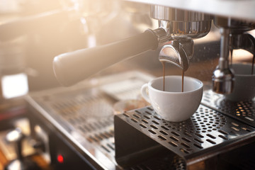 Espresso extraction from coffee machine in coffee shop. - 213587926