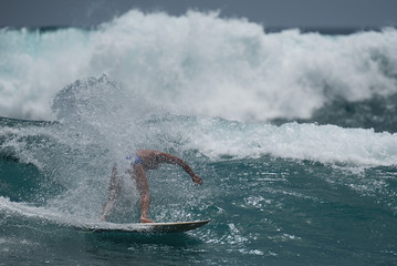 A surfer gets out in front of an enormous wave