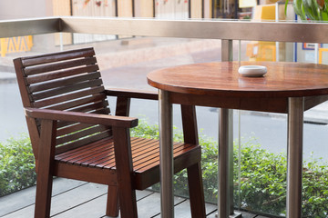 Empty table in front of blur coffee shop.