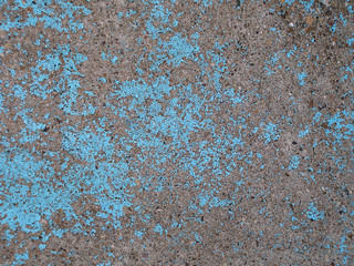 Old peeling blue paint on the concrete wall. Grunge stucco background