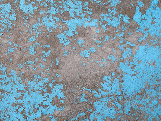Obraz premium Old peeling blue paint on the concrete wall. Grunge stucco background