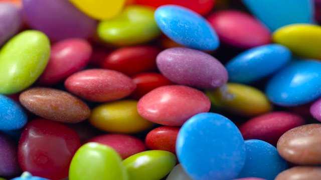 Macro closeup of multi color candy and jellies, dolly shot.