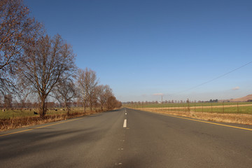 Fototapeta premium Long road through the countryside