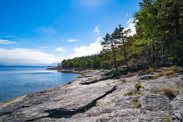 Beach with stones in Norway on a summer day