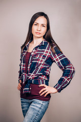 A young hipster girl on gray background