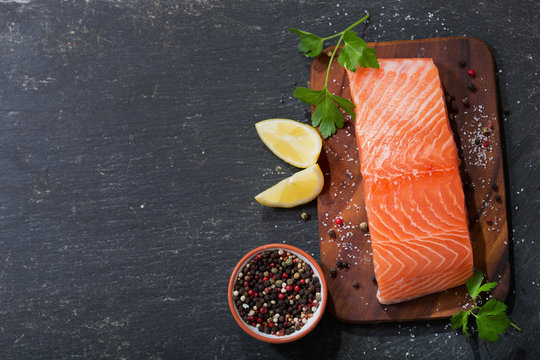 fresh salmon fillet with ingredients for cooking, top view