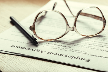 Close up shot of Eyeglasses  on contract document papers business concept