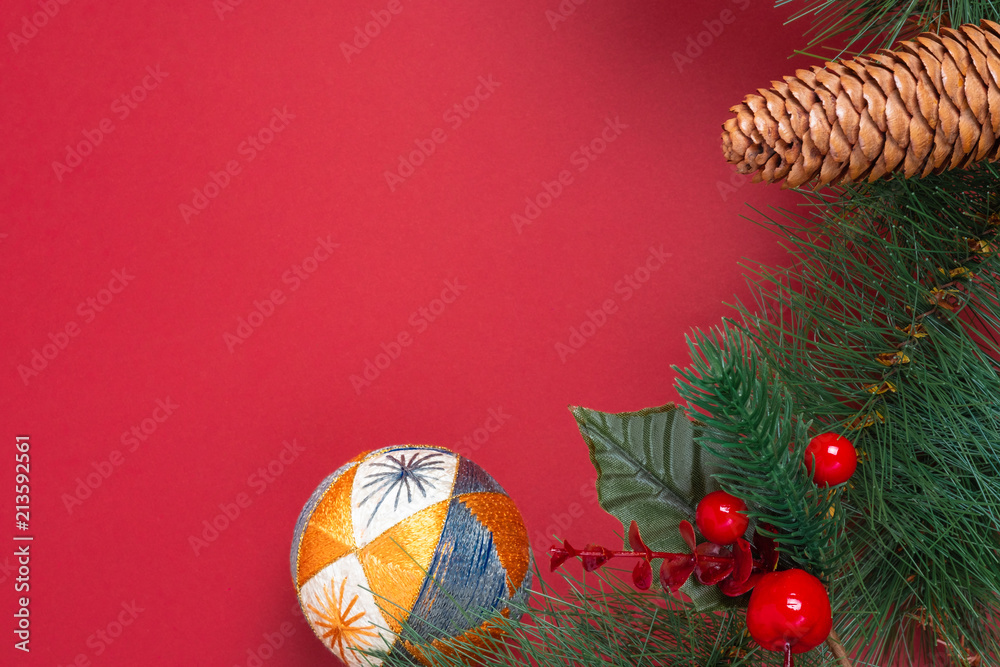Poster christmas decoration and fir branches wreath with cherry and pine cone on red table background. wint