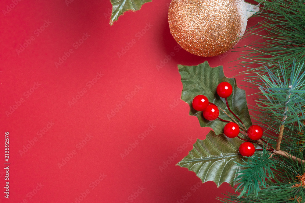 Poster christmas decoration and fir branches wreath with cherry and pine cone on red table background. wint