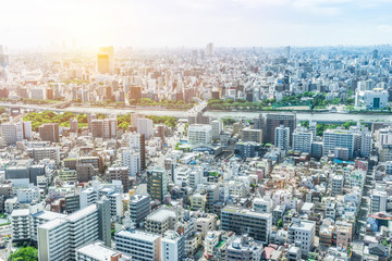 Asia Business concept for real estate and corporate construction - panoramic modern city urban skyline bird eye aerial view under sun & blue sky in Tokyo, Japan