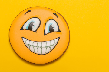 cookie smile and emotions, open mouth, baby gingerbread, on yellow background, concept