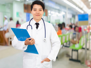 woman doctor holding Blank paper clipboard,and filling smile on gray background.