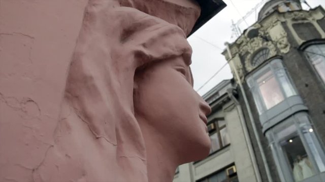 Sculpture of the woman face on the wall of an old house in St. Petersburg