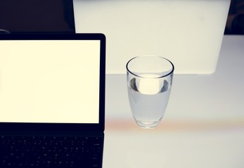 Hands with smartphone and laptop on the table