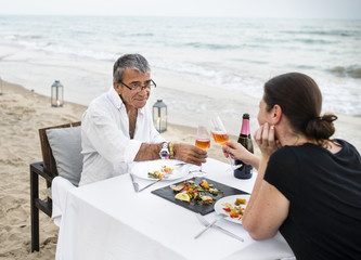 Couple enjoying a romantic dinner at the beach