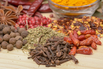 Various spices on wooden background.